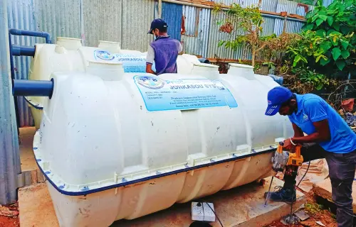 An image of two engineering experts engaging in their work at the Johkasou Compact Sewer System.